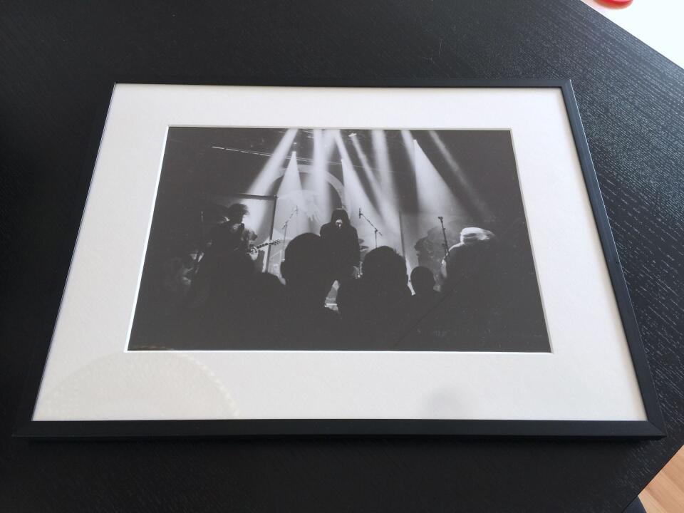 Another large black and white print of a live concert.