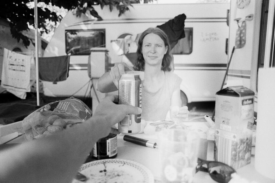 Holding my beer, saying cheers to Nicole at our camping table.