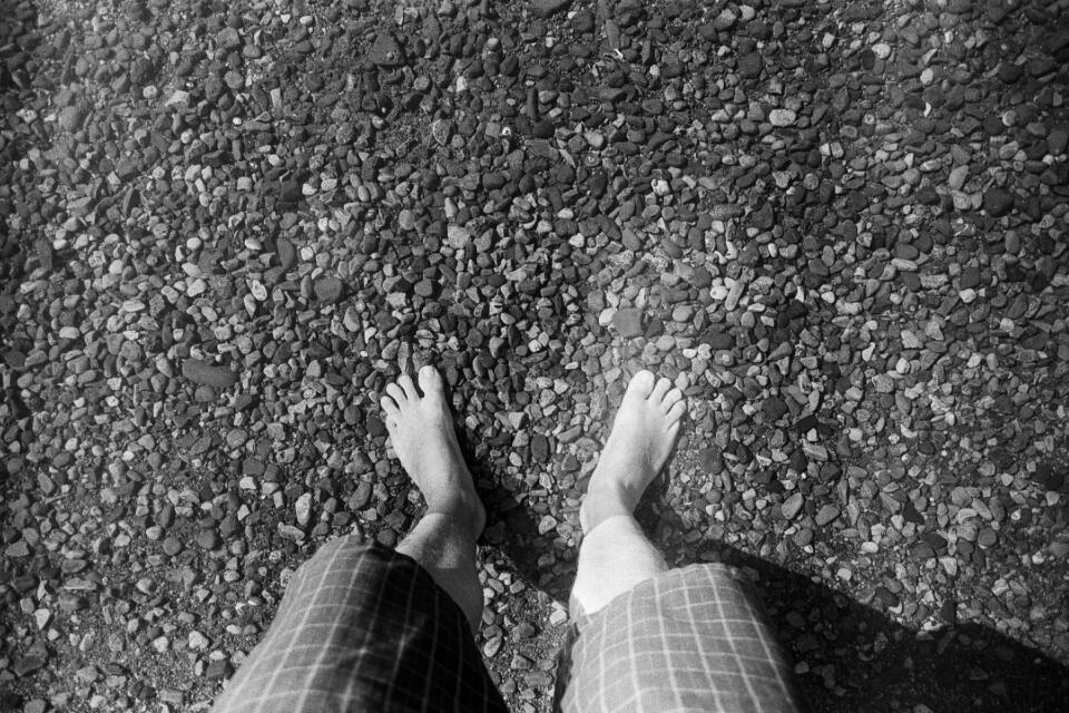 Bare feet in a clear lake.