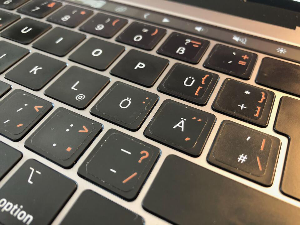 A close-up of my MacBook's keyboard, showing the right side of the keyboard, including the English key stickers on it.
