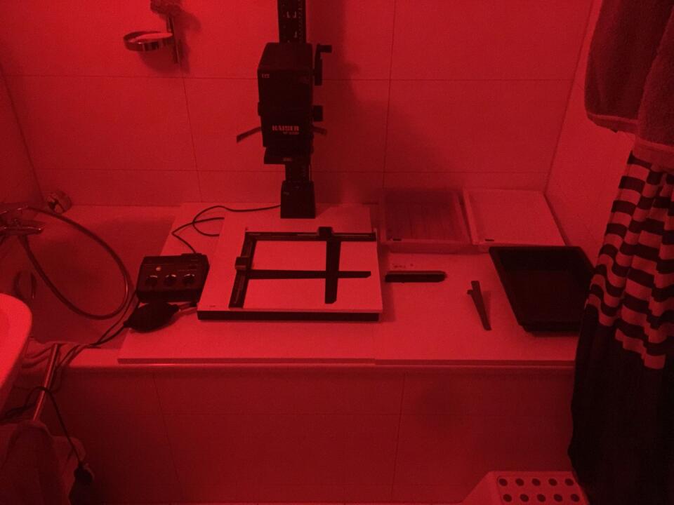 A photo of the same bathtub and setup as above, but with the red safelight turned on (making everything look red).